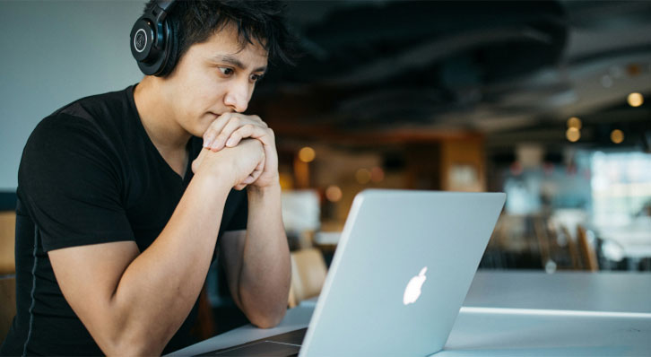 man with headphones on the computer